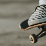 Close up shot of someone's foot on a skateboard doing a trick
