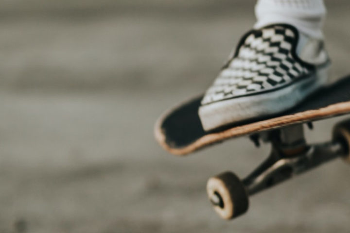 Close up shot of someone's foot on a skateboard doing a trick