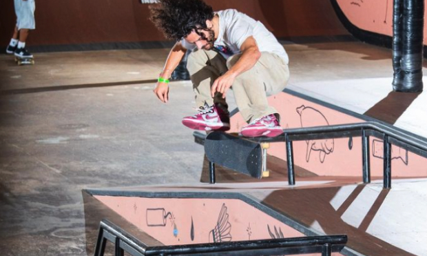 skateboarder flipping his board on ramp