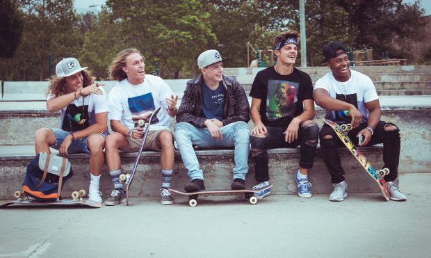 Group of young boys sitting on a ramp at a skatepark having a laugh for the is skateboarding good for you blog post